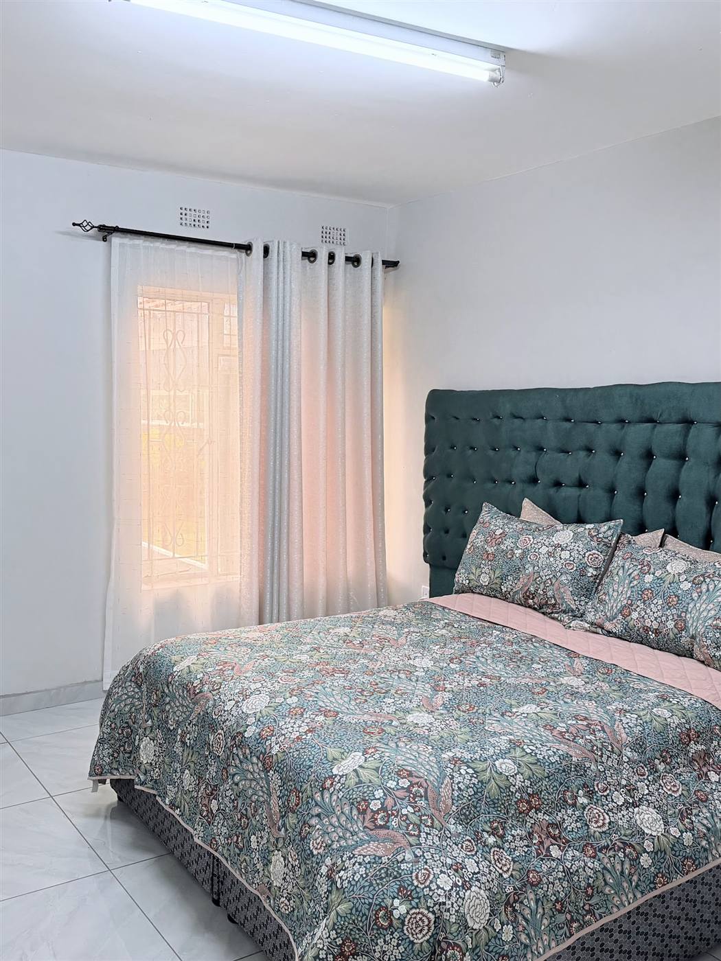 En-suite guest room at Eland Sanctuary B&B in Chimanimani with plush headboard and quality bedding